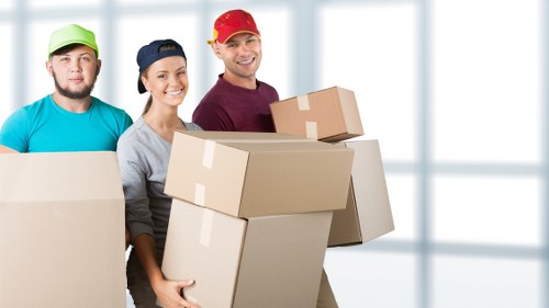 Boxes and furniture being loaded into a removals van