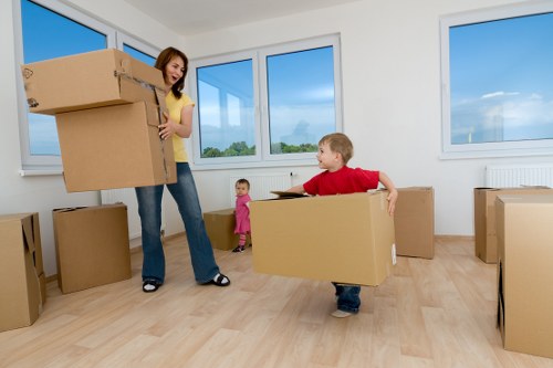 Movers carrying furniture for a local Golders Green flat move