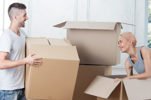 Removal company team handling household furniture move in Golders Green