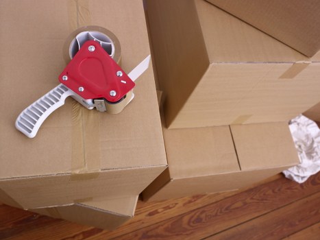 Packed boxes and furniture ready for collection by movers